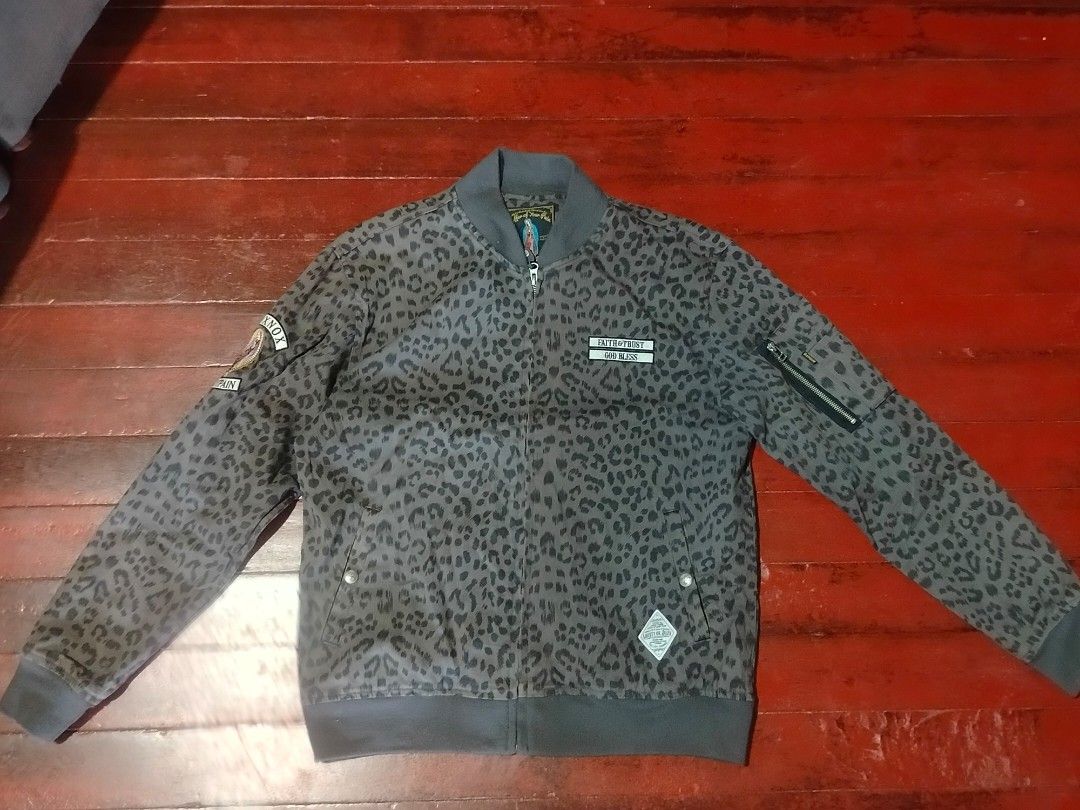The Saintpain Leopard Print Bomber Jacket (Category: Coats, Jackets and Outerwear) located in Manila. Submitted by carlosrexc26753 (Listing ID 1463973274, Image 1). Description: - Grey leopard print bomber jacket - Brand: The Saintpain - Size: M - Features patches: "FAITH & TRUST GOD BLESS" and "THE SAINTPAIN MOXNOX" - Zipper closure - Zippered pocket on sleeve - Cool statement piece.