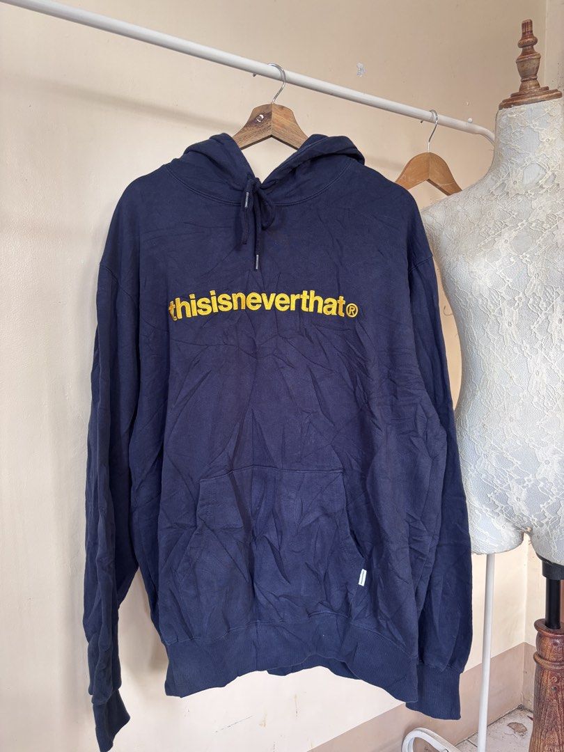 thisisneverthat Navy Blue Hoodie XL (Category: Coats, Jackets and Outerwear) located in Manila. Submitted by galitsabarat (Listing ID 1464077621, Image 2). Description: EXCELLENT CONDITION COLOR MAY VARY DUE TO LIGHTING IMBROIDED GOLD SCRIPT LOGO 9.7/10 color rate 24.5x29 dimes heavy weight fresh from bale kaya malukot - Brand: thisisneverthat - Color: Navy Blue - Size: XL - Features: Signature yellow logo on front, front pocket, drawstring hood 