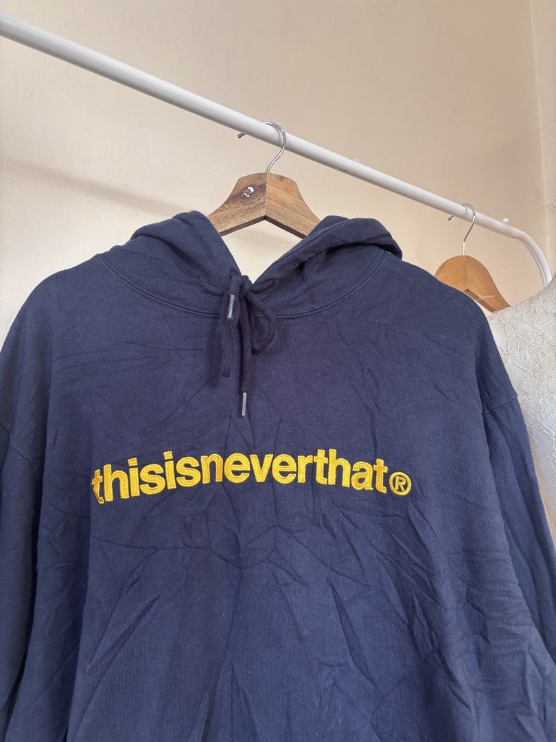 thisisneverthat Navy Blue Hoodie XL (Category: Coats, Jackets and Outerwear) located in Manila. Submitted by galitsabarat (Listing ID 1464077621, Image 3). Description: EXCELLENT CONDITION COLOR MAY VARY DUE TO LIGHTING IMBROIDED GOLD SCRIPT LOGO 9.7/10 color rate 24.5x29 dimes heavy weight fresh from bale kaya malukot - Brand: thisisneverthat - Color: Navy Blue - Size: XL - Features: Signature yellow logo on front, front pocket, drawstring hood 