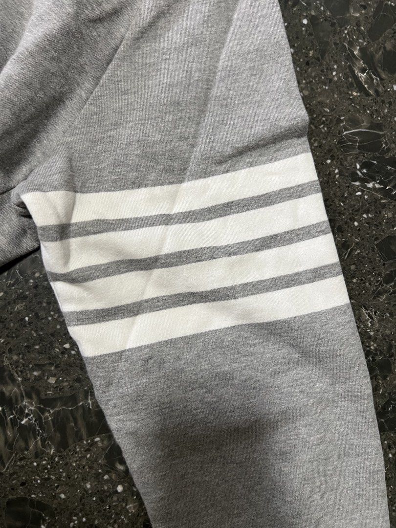 Thom Browne Grey Zip-Up Hoodie Size 3 (Category: Hoodies) located in Manila. Submitted by justin_sy (Listing ID 1463982647, Image 3). Description: - Grey Thom Browne zip-up hoodie - Signature four-stripe detail on sleeve - Made in Japan - Size 3 - Silver-tone zipper.