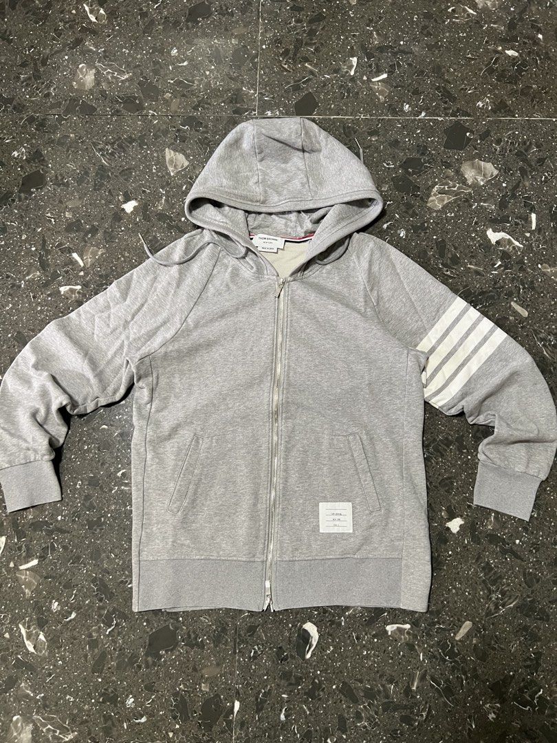 Thom Browne Grey Zip-Up Hoodie Size 3 (Category: Hoodies) located in Manila. Submitted by justin_sy (Listing ID 1463982647, Image 1). Description: - Grey Thom Browne zip-up hoodie - Signature four-stripe detail on sleeve - Made in Japan - Size 3 - Silver-tone zipper.