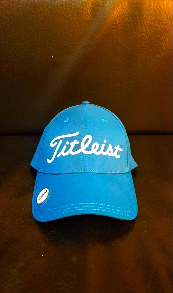 Titleist Golf Cap - Blue green (Category: Caps & Hats) located in Makati City. Submitted by jules000 (Listing ID 1463427921, Image 1). Description: - Classic blue Titleist golf cap - Features embroidered Titleist script logo on the front - Includes a small Titleist ball marker attached to the brim - Adjustable strap at the back for a customized, comfortable fit - Ideal for protection and style on the golf course on sunny days.