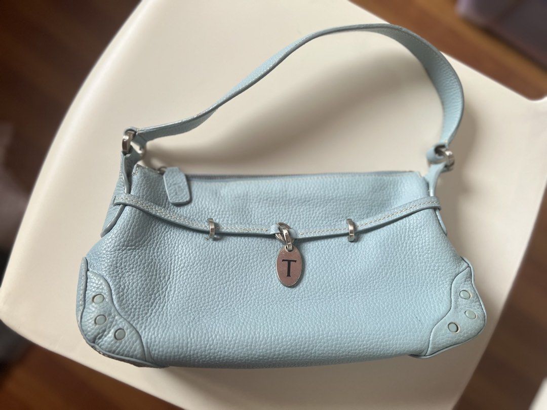 Tod's Light Blue Leather Shoulder Bag (Category: Shoulder Bags) located in Quezon City. Submitted by kaye_mm (Listing ID 1463955122, Image 2). Description: ✨ Description & Details Up for sale is a stunning, authentic vintage Tod’s Belted Shoulder Bag crafted from premium, butter-soft grained calfskin leather in a gorgeous sky blue hue. This iconic bag features contrast cream topstitching, signature silver-tone hardware, and a prominent metal “T” 