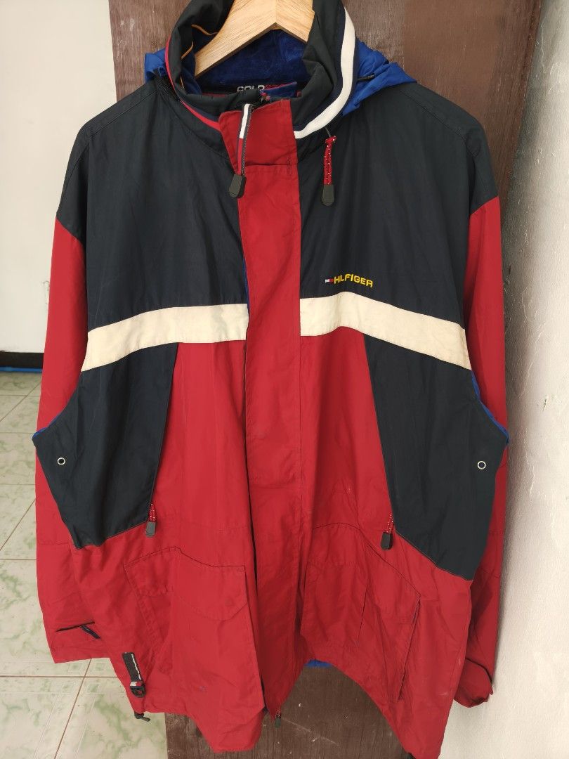 Tommy Hilfiger Cold Stop Jacket Red Navy Blue (Category: Coats, Jackets and Outerwear) located in Manila. Submitted by truehorse-68cf (Listing ID 1463953188, Image 1). Description: - Vintage Tommy Hilfiger jacket - Classic red, navy, and white color block design - Features a hood - Multiple zip pockets for secure storage - Blue interior lining with Tommy Hilfiger pattern - Ideal for cooler weather - Size XXL vintage excellent condition accepting 