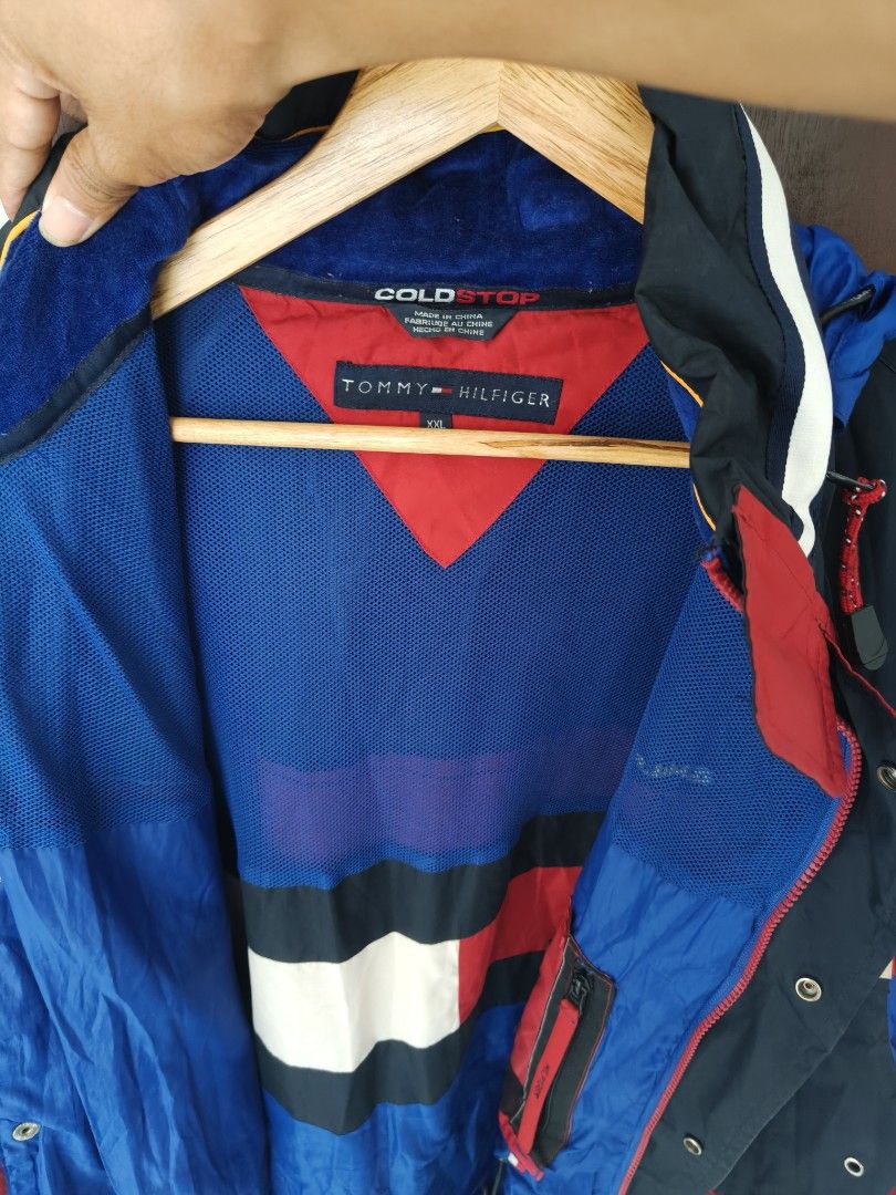 Tommy Hilfiger Cold Stop Jacket Red Navy Blue (Category: Coats, Jackets and Outerwear) located in Manila. Submitted by truehorse-68cf (Listing ID 1463953188, Image 3). Description: - Vintage Tommy Hilfiger jacket - Classic red, navy, and white color block design - Features a hood - Multiple zip pockets for secure storage - Blue interior lining with Tommy Hilfiger pattern - Ideal for cooler weather - Size XXL vintage excellent condition accepting 
