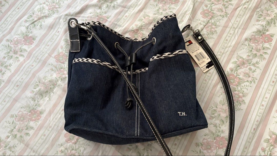 Tommy Hilfiger Denim Drawstring Bucket Bag (Category: Shoulder Bags) located in Manila. Submitted by tsukkisell (Listing ID 1463996265, Image 1). Description: - Cute Tommy Hilfiger denim bucket bag - Drawstring closure - Adjustable strap - Embroidered 'T.H.' monogram on front - Black interior with zippered pocket - Comes with original tags attached OP: $49 from the US.