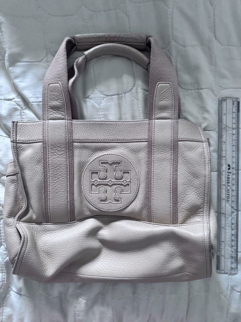 Tory Burch Beige Leather Shopper Tote Beige (Category: Luxury Bags & Wallets) located in Makati City. Submitted by mbrtom (Listing ID 1464011700, Image 1). Description: As is. Scuffs seen in photos on the corners. Nice leather and shade of beige. Good casual weekend purse with side pockets for small umbrella and extra eco bag. Authentic / Original. Purchased in the US..