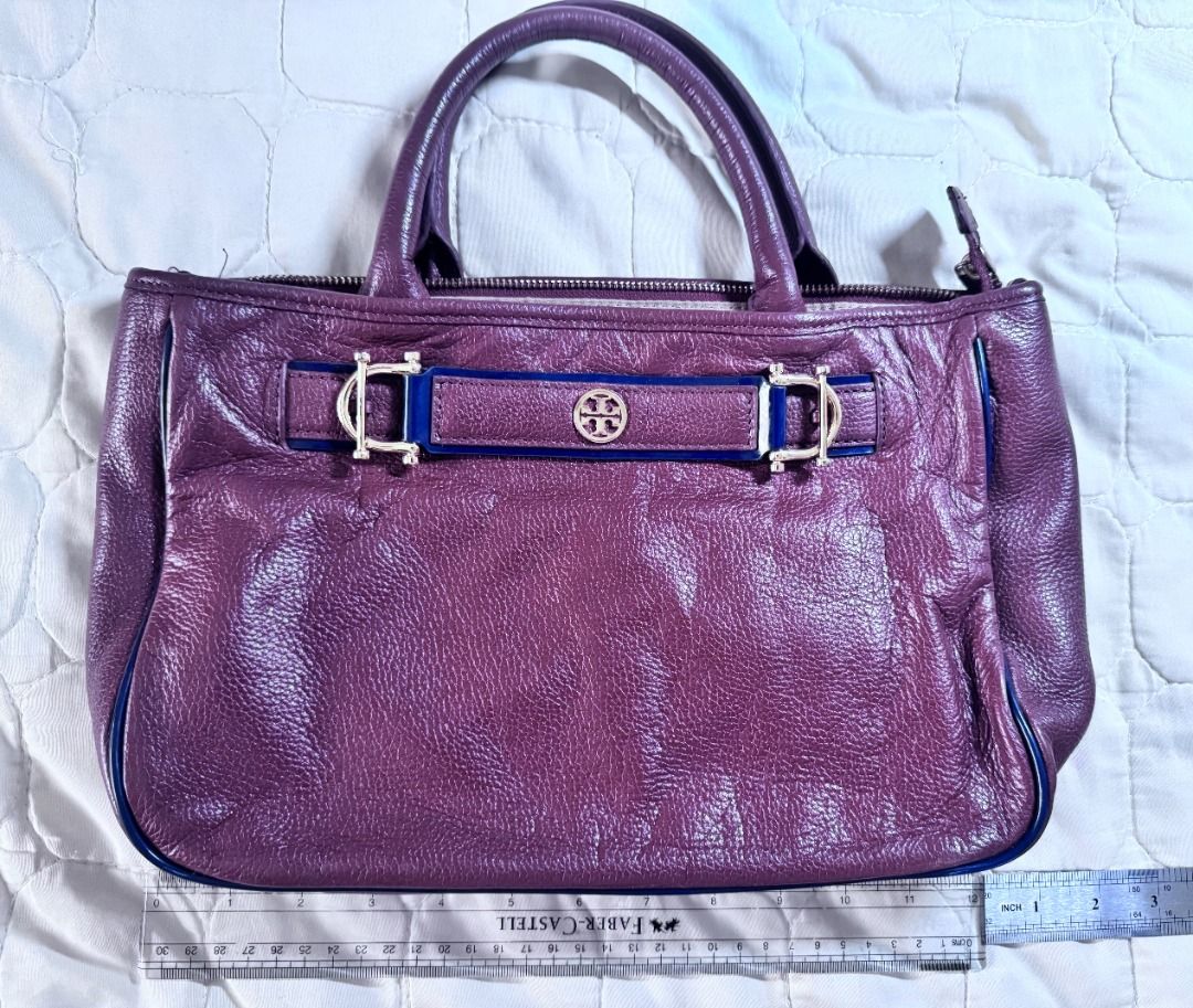 Tory Burch Brown Horsebit Satchel (Category: Luxury Bags & Wallets) located in Makati City. Submitted by mbrtom (Listing ID 1463989665, Image 1). Description: As is. Stained lining from use and storage. Strap not included. Smooth zipper. Thread / stiches coming off from one strap hook. Outside leather in very good condition. No scuffs and navy blue piping intact. Good size for a daily bag. Zipper also provides some safety for personal effects. Au
