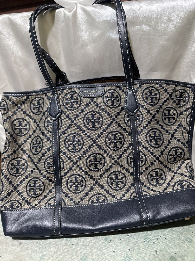 Tory Burch Tote Bag (Category: Tote Bags) located in Balanga. Submitted by jk2025. (Listing ID 1463958390, Image 1). Description: - Classic Tory Burch tote bag - Iconic all-over logo pattern - Durable canvas with leather trim - Sturdy and comfortable straps - Spacious interior for essentials - Ideal for everyday use or travel.