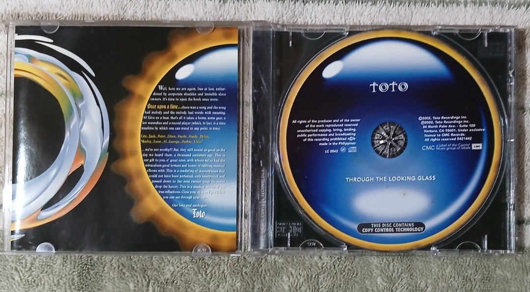 Toto: Through the Looking Glass CD (Category: CDs & DVDs) located in Manila. Submitted by miczngrz (Listing ID 1463951720, Image 3). Description: * Artist: Toto * Album: Through the Looking Glass * Price: 550 (buy 2 or more CDs from my listings to get a discount) * Release date: 2002 * Features cover songs from various artists * Includes Copy Control technology * A must-have for any Toto fan's collection * Tracklist: Could You Be Loved Bodhisattv