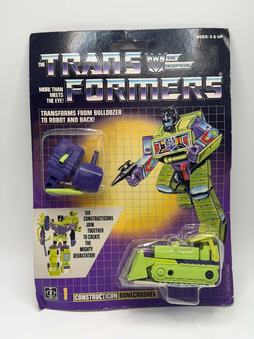 Transformers G1 Constructions Set of 3 (Category: Action & Battle Toys) located in Lipa City. Submitted by vintage.ube.pots (Listing ID 1464086251, Image 1). Description: Three original 1985 Transformers G1 Constructions all still on the card, bubbles, unopened, never played. Bone crusher #1: bulldozer, Devastator's left arm Scrapper #3: payloader, Devastator's right leg with super wing Long haul # 5: dump truck, Devastator's torso Authentic: Wit