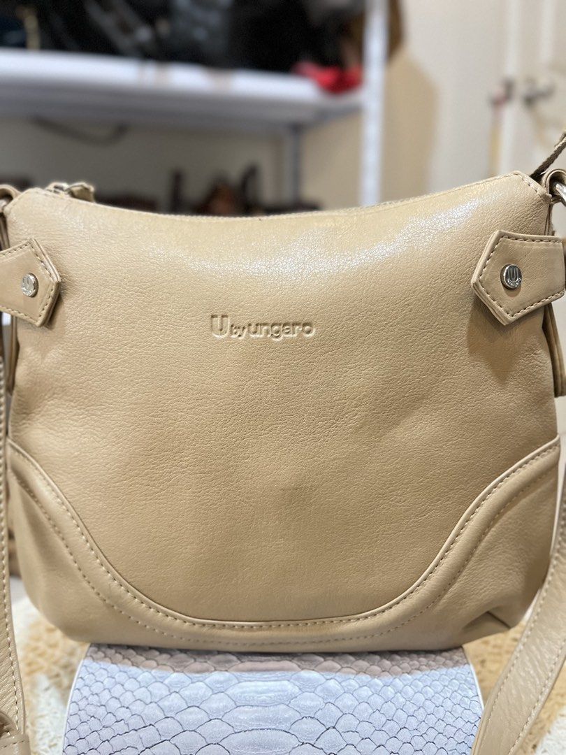 Ungaro Beige Leather Shoulder Bag (Category: Shoulder Bags) located in Bacolod City. Submitted by vintage_vogue6100 (Listing ID 1464017990, Image 1). Description: - Beige leather shoulder bag by Ungaro - Zip closure with front pocket - Interior: Pink satin lining with zip and slip pockets - Detachable strap included - Ideal size for everyday use.