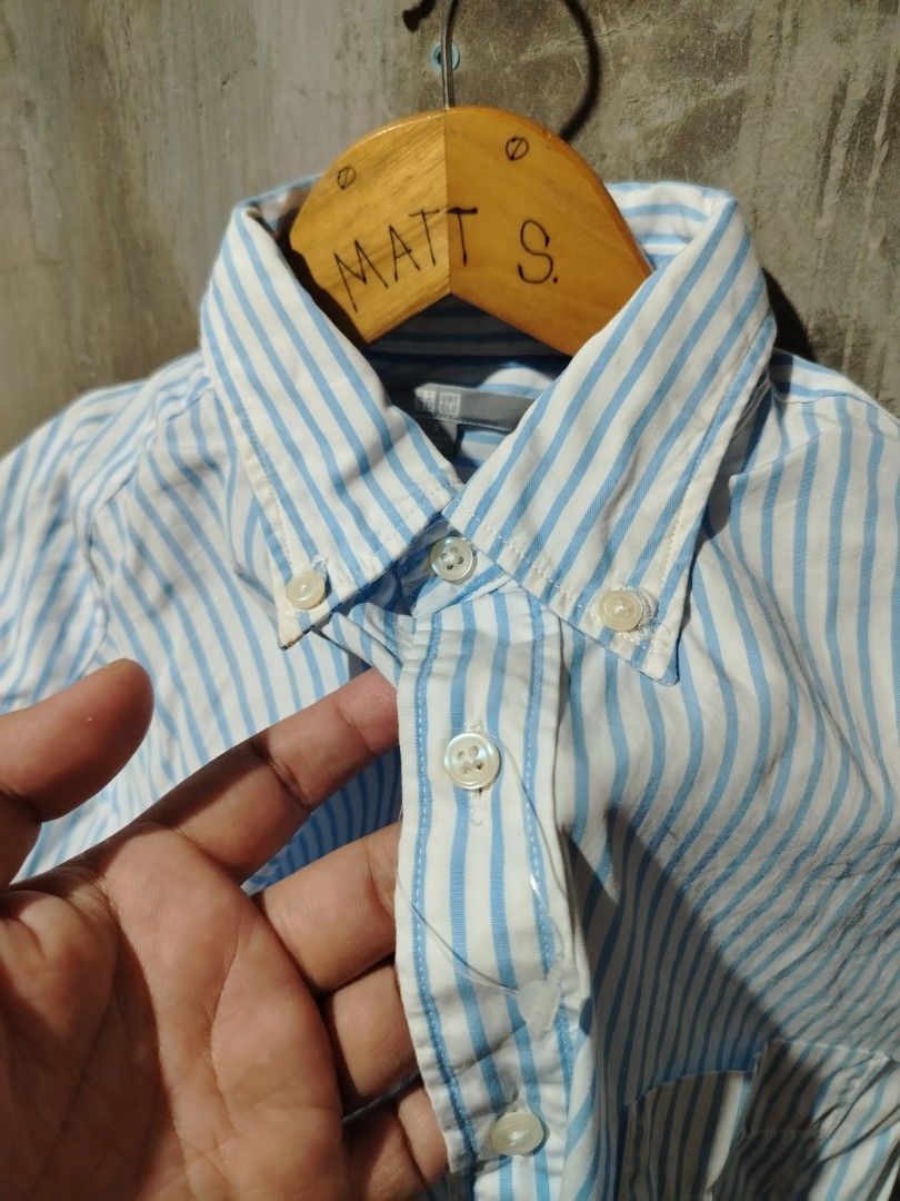 Uniqlo Blue Striped Button-Up Shirt (Category: Tshirts & Polo Shirts ) located in Tagum. Submitted by kotasallys40096 (Listing ID 1464108224, Image 3). Description: - Uniqlo Button-Up Shirt - 19*26 - Color: Light Blue & White Stripes - Collar: Classic Button-Down - Features: Chest Pocket - Material: 100% Cotton - Size: S - Style: Versatile for casual or smart-casual occasions.