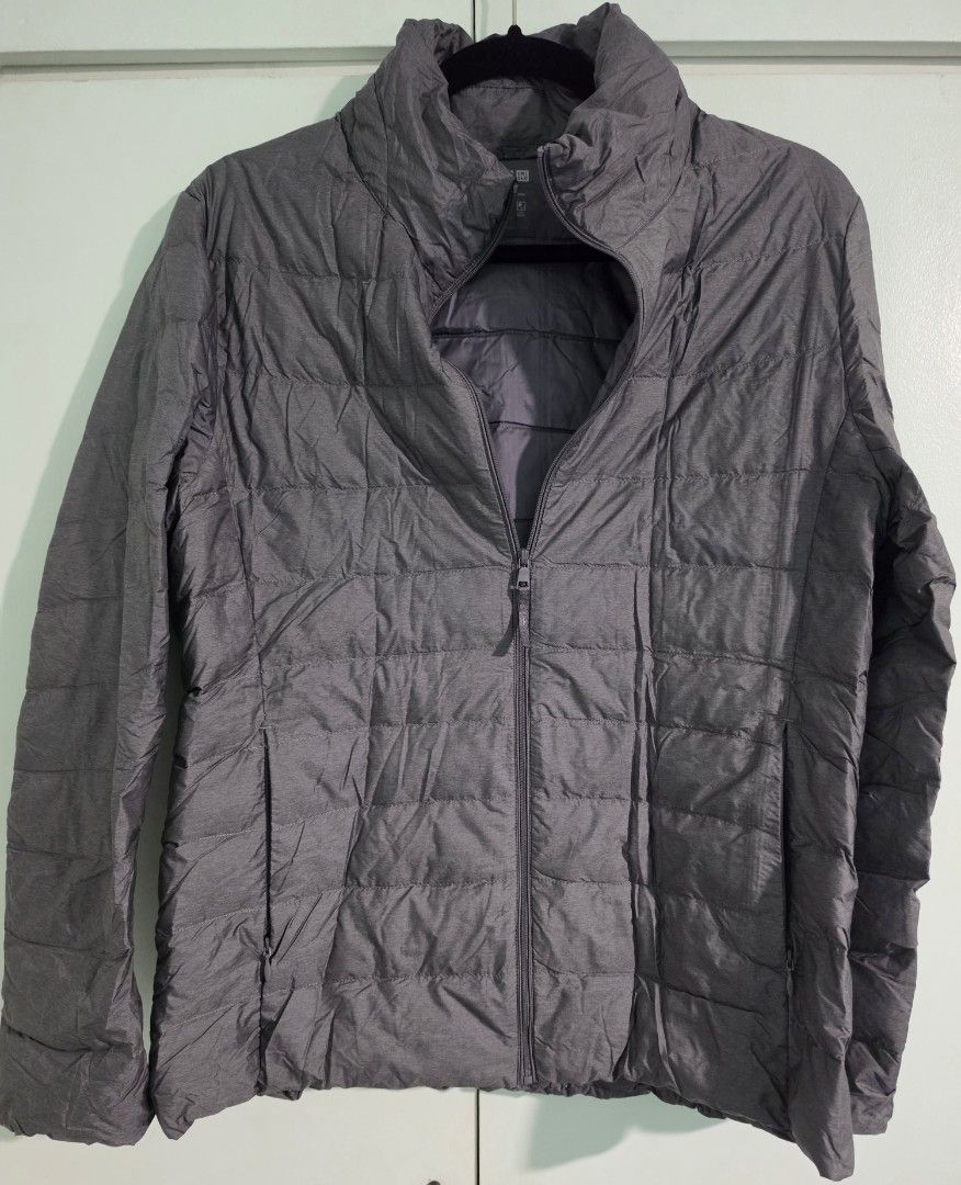 Uniqlo Ultra Light Down Zip Up Jacket Grey (Category: Coats, Jackets and Outerwear) located in Mandaluyong City. Submitted by decluttering.tita (Listing ID 1463993721, Image 2). Description: - Uniqlo Ultra Light Down jacket - Color: Grey - Size: Women's Extra Large (XL) - Features: Super lightweight, packable with included pouch, zipped pockets - Zippers all working - Garterized sleeves - Ideal for: Travel, layering - Reason for selling: Owner ha