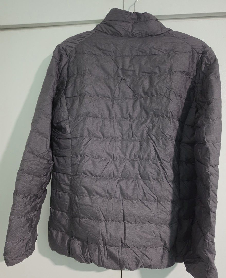 Uniqlo Ultra Light Down Zip Up Jacket Grey (Category: Coats, Jackets and Outerwear) located in Mandaluyong City. Submitted by decluttering.tita (Listing ID 1463993721, Image 3). Description: - Uniqlo Ultra Light Down jacket - Color: Grey - Size: Women's Extra Large (XL) - Features: Super lightweight, packable with included pouch, zipped pockets - Zippers all working - Garterized sleeves - Ideal for: Travel, layering - Reason for selling: Owner ha