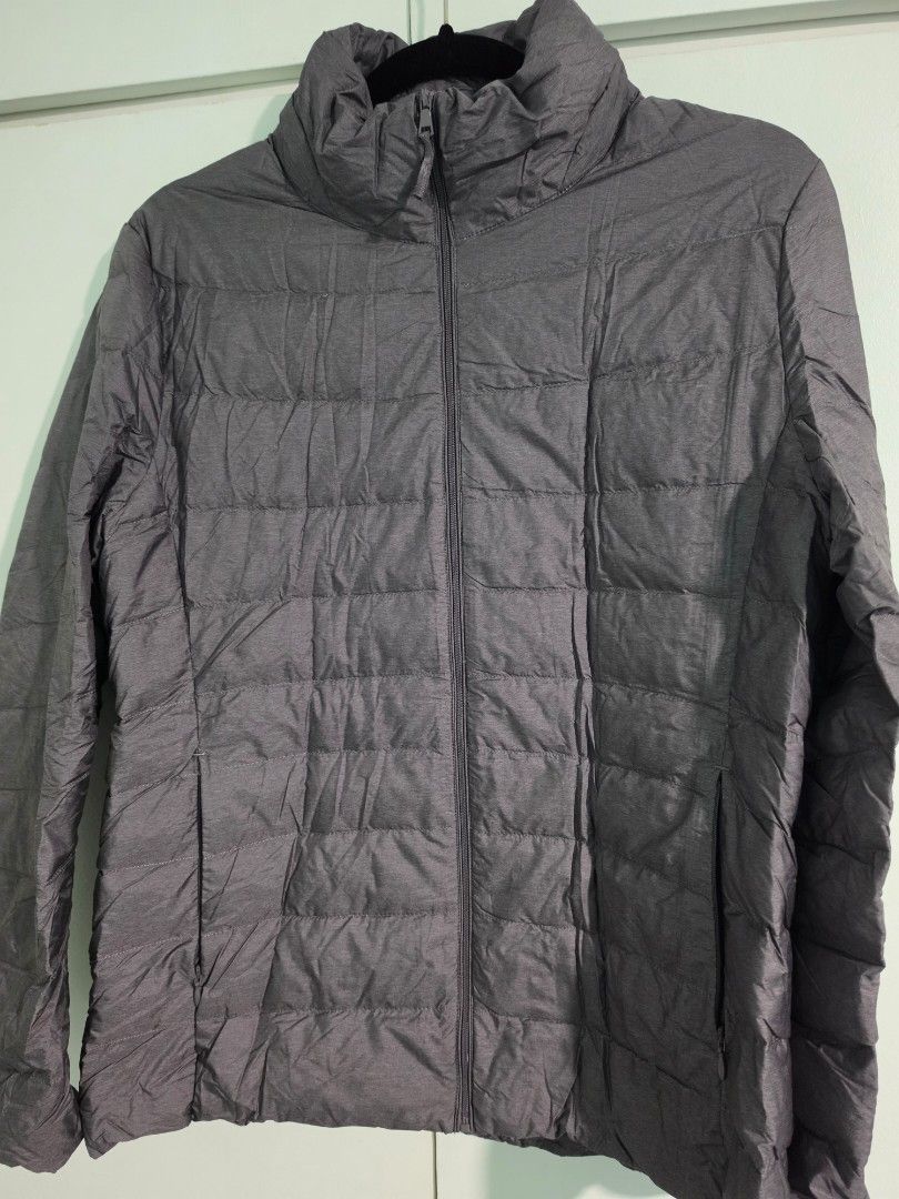 Uniqlo Ultra Light Down Zip Up Jacket Grey (Category: Coats, Jackets and Outerwear) located in Mandaluyong City. Submitted by decluttering.tita (Listing ID 1463993721, Image 1). Description: - Uniqlo Ultra Light Down jacket - Color: Grey - Size: Women's Extra Large (XL) - Features: Super lightweight, packable with included pouch, zipped pockets - Zippers all working - Garterized sleeves - Ideal for: Travel, layering - Reason for selling: Owner ha