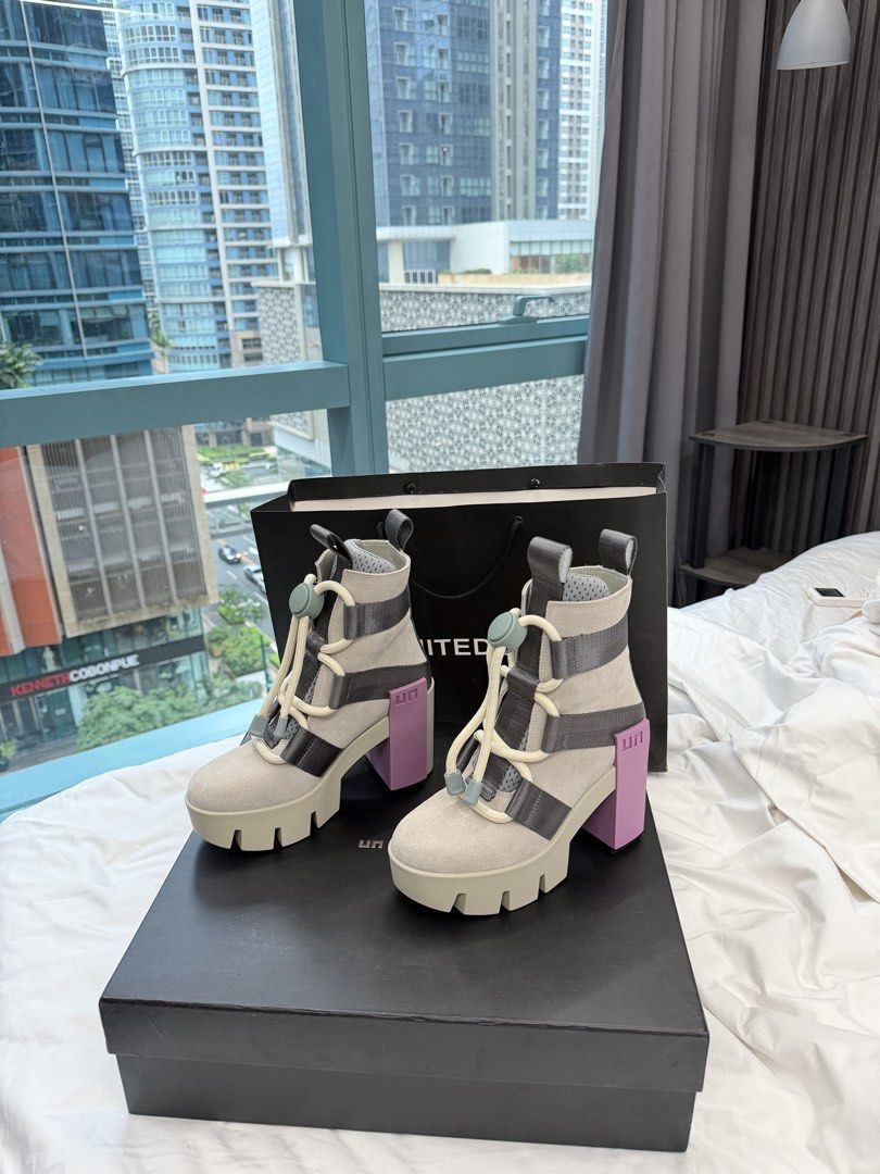 United Nude Chunky Heel Boots (Category: Boots) located in Manila. Submitted by angelmoniquetubo (Listing ID 1464018699, Image 1). Description: - Brand: United Nude - Style: Boots - Features: Unique chunky heel with purple accents - Closure: Lace-up front with toggle - Includes: Original box and dust bag - Perfect for: Making a statement with your outfit.