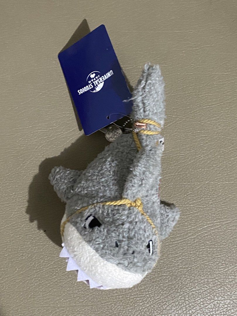 Universal Studios Japan Jaws Shark Plush Keychain (Category: Plushies & Soft Toys) located in Davao. Submitted by hoowans_surplus (Listing ID 1464067685, Image 1). Description: - Adorable Jaws shark plush from Universal Studios Japan - Features a convenient keychain attachment - Brand new with original tags still attached - Ideal for decorating bags or as a charming small gift.