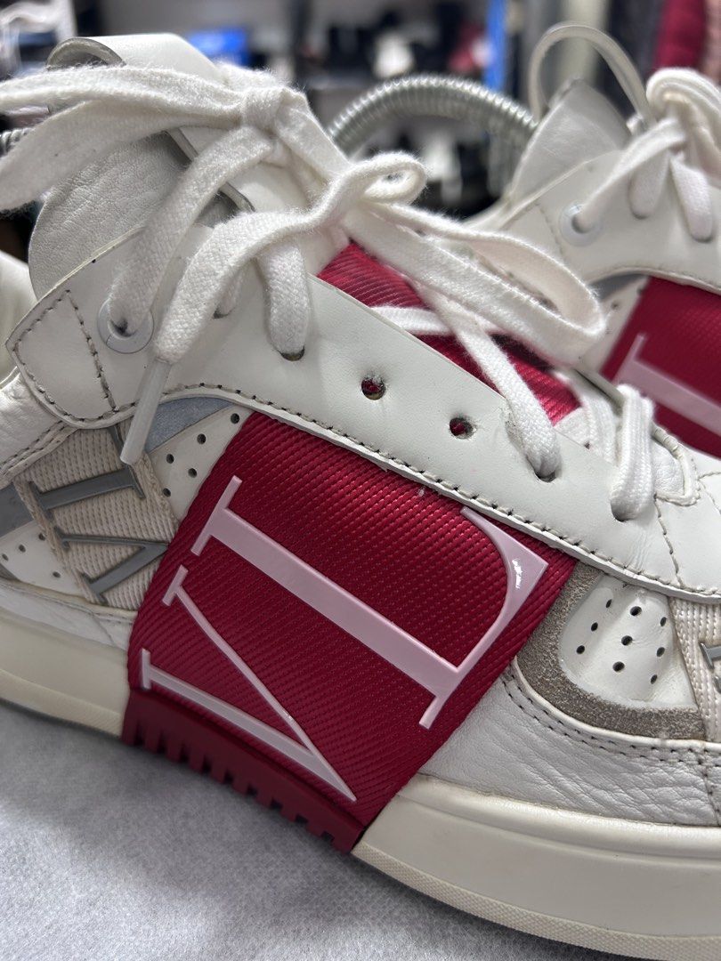 Valentino White Leather Rockstud Sneakers (Category: Sneakers) located in Pasig City. Submitted by blitzkriegspc (Listing ID 1464136374, Image 2). Description: - White leather Valentino low-top sneakers - Features iconic red VLTN strap - Rubber sole with minimal wear - Laces are clean - Comes with shoe trees.