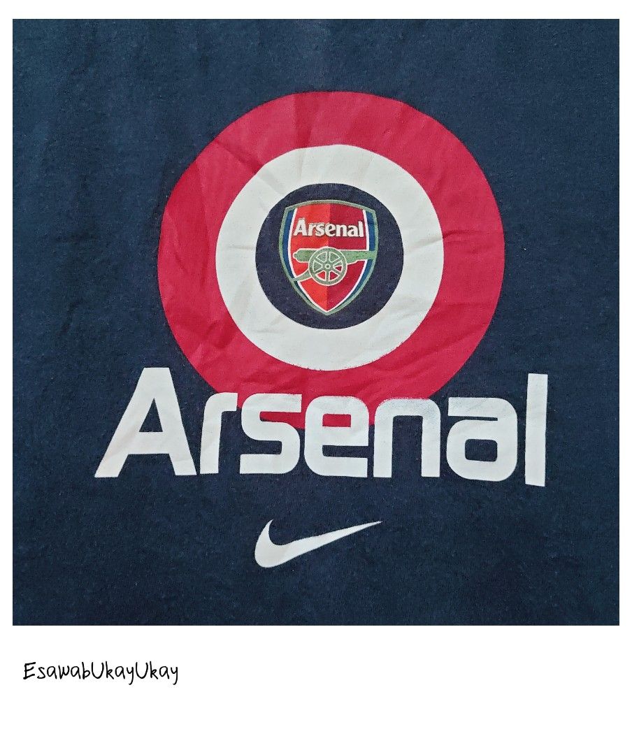 Vintage Arsenal Nike (Category: Activewear) located in Lucena. Submitted by esawabthriftshopatbp (Listing ID 1463960595, Image 2). Description: This is a vintage navy blue Nike Arsenal football t-shirt featuring a center swoosh and a red-and-white graphic crest on the chest..