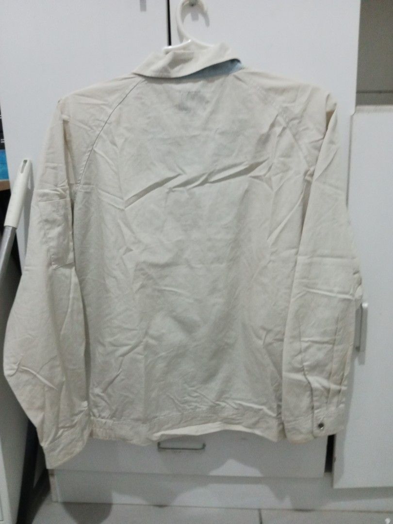 Vintage Beige Bomber Jacket (Category: Coats, Jackets and Outerwear) located in Manila. Submitted by lofiley (Listing ID 1464030831, Image 2). Description: - Classic beige bomber jacket - Zip-up front with button closure - Two front pockets with zip detail - Elasticated cuffs and hem - Ideal for layering - Simple and versatile design.