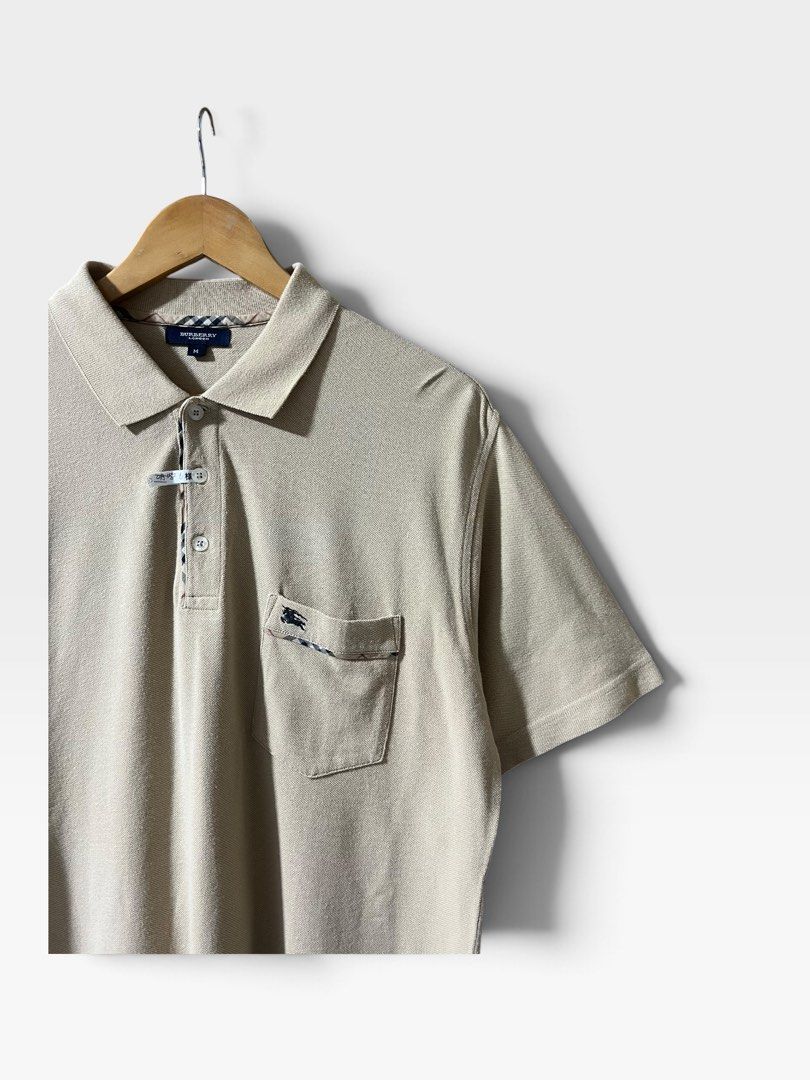 Burberry 2000s Nova Check Trim Polo Shirt (Category: Tshirts & Polo Shirts ) located in Tagum. Submitted by graveyard_archive.ph (Listing ID 1464058047, Image 2). Description: M on tag pasok L 21x29.5 Very Good Condition Cr: 9/10 Lints, minimal white line on underarm (not obvious) Burberry 2000s Nova Check Trim Polo Shirt This piece is a classic short-sleeve pique polo shirt from Burberry London, produced in the early to mid-2000s following the b