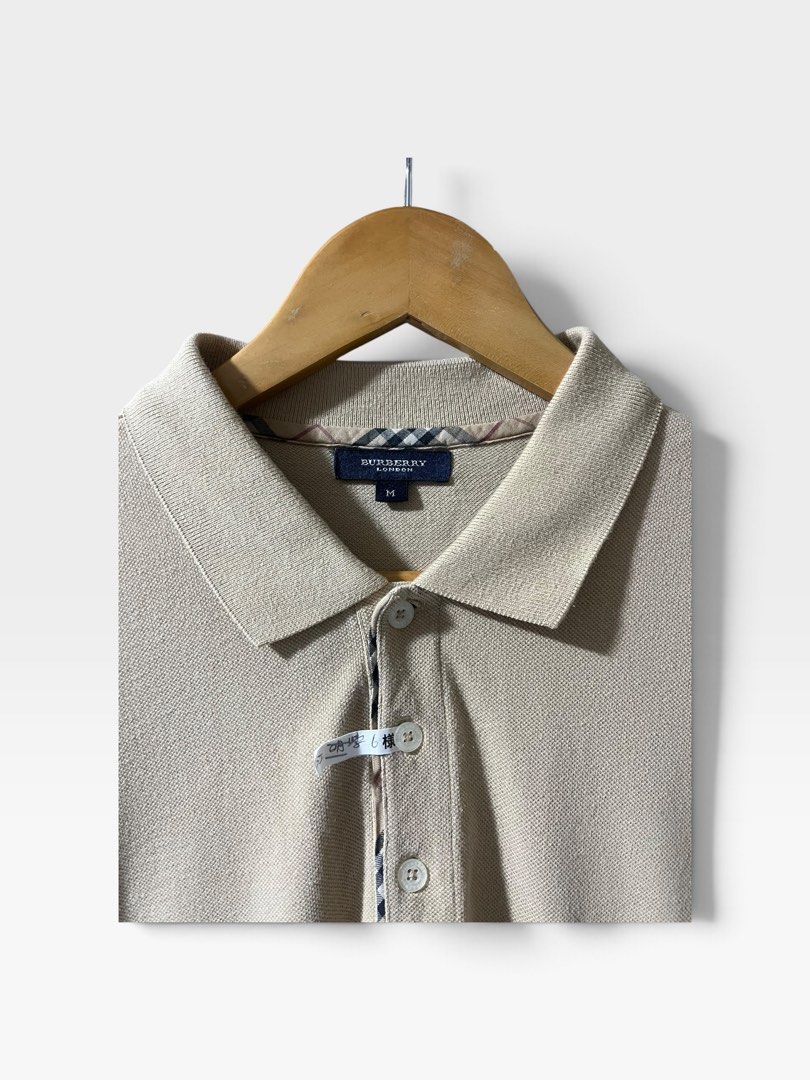 Burberry 2000s Nova Check Trim Polo Shirt (Category: Tshirts & Polo Shirts ) located in Tagum. Submitted by graveyard_archive.ph (Listing ID 1464058047, Image 3). Description: M on tag pasok L 21x29.5 Very Good Condition Cr: 9/10 Lints, minimal white line on underarm (not obvious) Burberry 2000s Nova Check Trim Polo Shirt This piece is a classic short-sleeve pique polo shirt from Burberry London, produced in the early to mid-2000s following the b