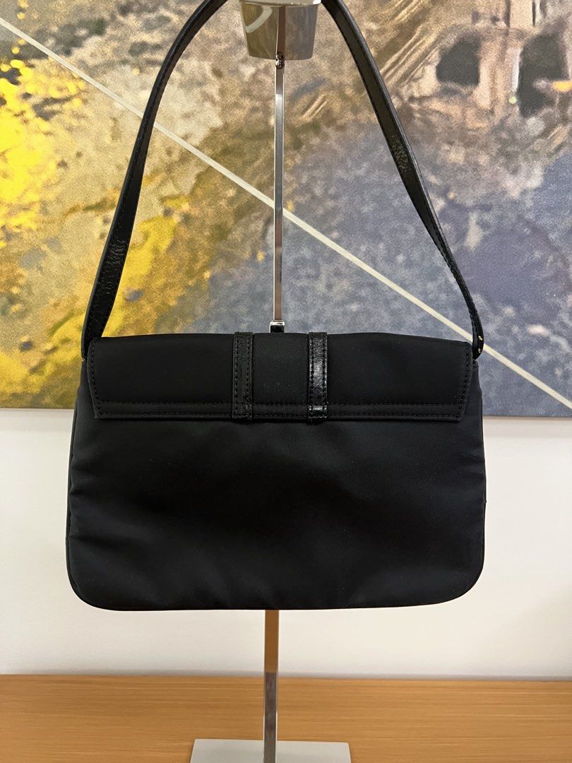 Vintage Givenchy Black Nylon Shoulder Bag (Category: Luxury Bags & Wallets) located in Manila. Submitted by pearlt455 (Listing ID 1463981725, Image 2). Description: - Authentic Vintage Givenchy black nylon shoulder bag - Y2K-style shoulder bag - Iconic Givenchy logo clasp closure - Interior zippered pocket for essentials - Condition: Used-wearable (pls see pics) .
