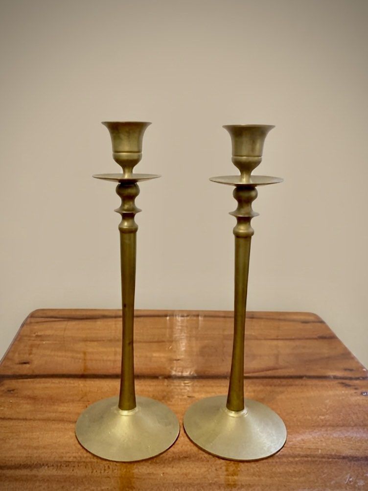 Vintage Solid Brass Taper Candlestick holders in Pair (Category: Vintage Collectibles) located in Nagcarlan. Submitted by snccollection (Listing ID 1463991455, Image 1). Description: These are a pair of vintage solid brass taper candlestick holders, featuring long slender stems, flared round bases, and decorative knopped detailing with drip pans just below the candle cups. (10 inches in height) .