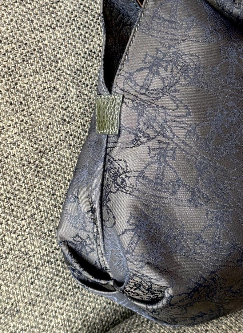 Vivienne Westwood Orb Pattern Handbag (Category: Luxury Bags & Wallets) located in San Fernando. Submitted by viviennegyal (Listing ID 1464071306, Image 3). Description: Fall in love with earth tones and vintage orbs with this Vivienne Westwood Ring-Handle Hobo. 🫒 Made from a monogram nylon, jacquard fabric in an olive and brown-grey hue covered in an repeating sketched watermark Orb motif, paired with leather-wrapped handles. This unique bag da