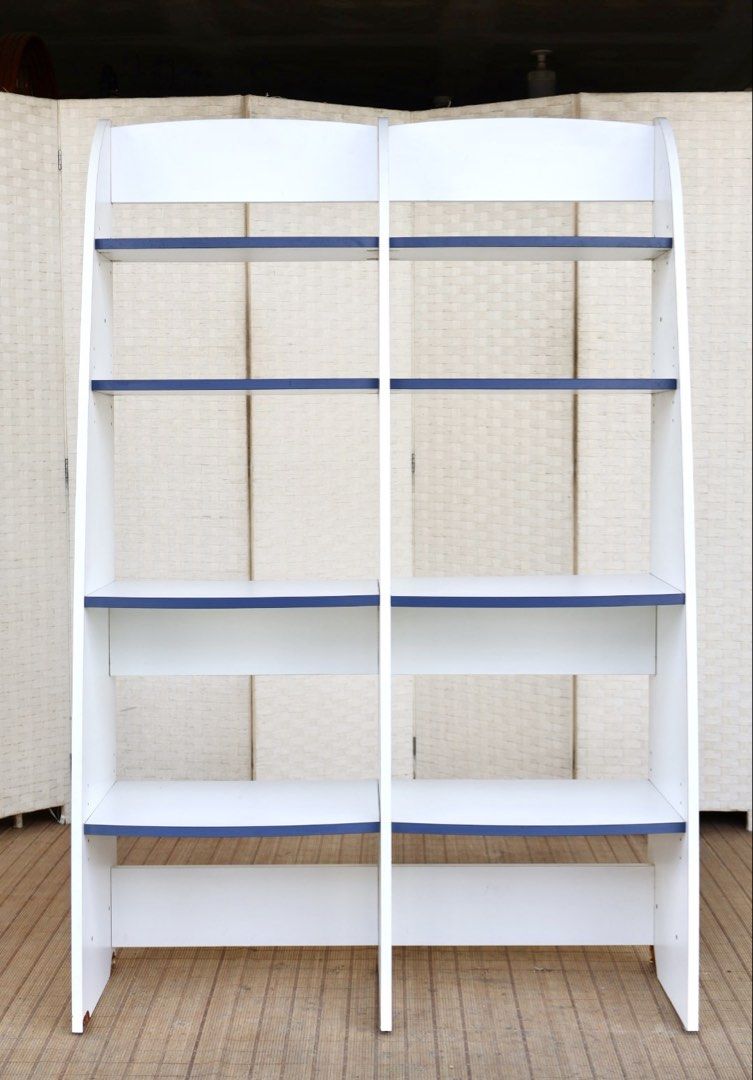 White and Blue 2-Tier Bookshelf Display Shelf (Category: Shelves, Cabinets & Racks) located in Bulacan. Submitted by FurnitureGallery (Listing ID 1463996604, Image 1). Description: - White bookshelf with stylish blue shelf accents - Two separate units, can be placed together or separately - Each unit features four spacious shelves - Perfect for organizing books, displaying decor, and more - Dimensions: Approx. [insert height] tall x [insert width