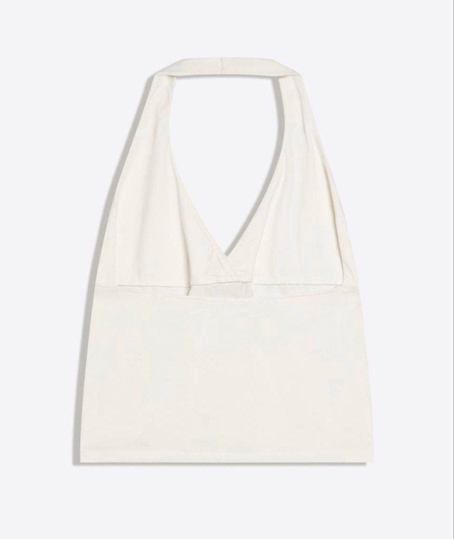 White Halter Top (Category: Others Tops) located in Manila. Submitted by chicdistrict.ph (Listing ID 1463976853, Image 3). Description: - White halter top with V-neck and adjustable neck tie - Matching simple canvas tote bag with single strap - Ideal for a casual, beachy, or everyday look - Both items are in good, pre-loved condition.