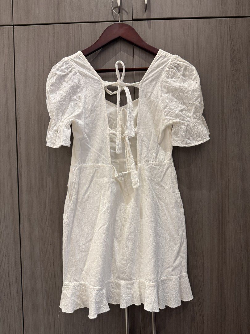 White Linen Eyelet Mini Dress (Category: Dresses) located in Quezon City. Submitted by declutteringmycloset__ (Listing ID 1463949197, Image 2). Description: - Cute white mini dress - Puff sleeves with eyelet details - Square neckline with back tie - Ruffled hem - Has pockets - Ideal for summer outings or casual wear.