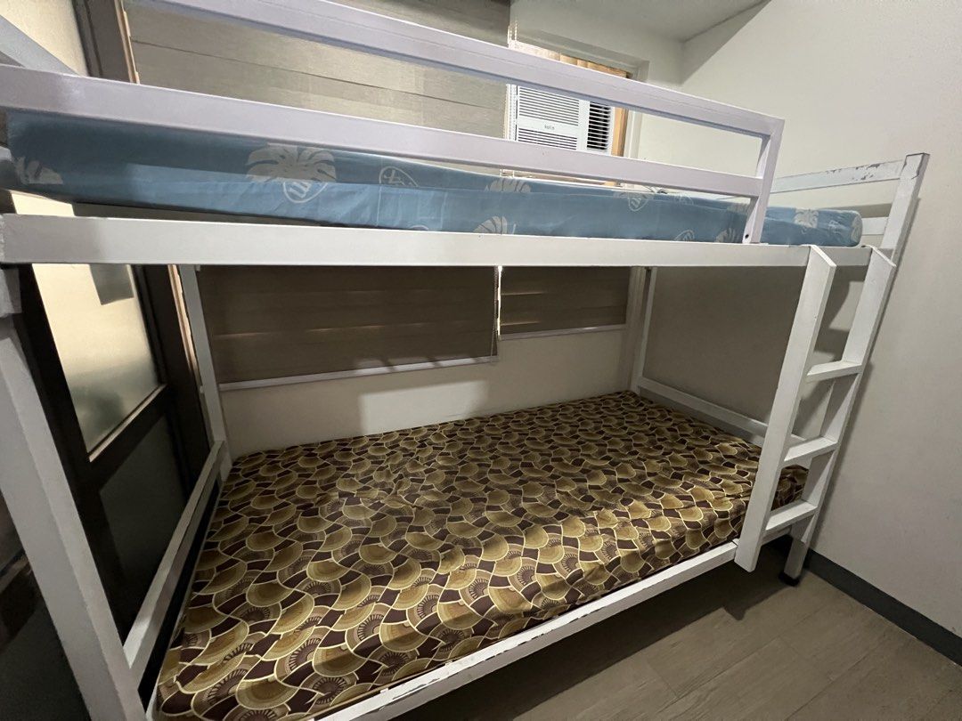 White Metal Bunk Bed (Category: Bed Frames & Mattresses) located in Mandaluyong City. Submitted by aamendoza (Listing ID 1464028241, Image 2). Description: - Sturdy white metal bunk bed frame - Minor scuffs and scratches from normal use - Excellent space-saving solution for bedrooms.