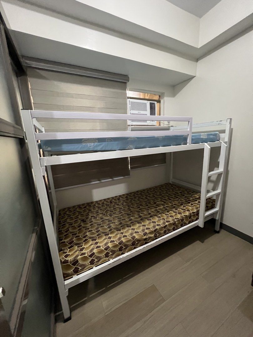 White Metal Bunk Bed (Category: Bed Frames & Mattresses) located in Mandaluyong City. Submitted by aamendoza (Listing ID 1464028241, Image 1). Description: - Sturdy white metal bunk bed frame - Minor scuffs and scratches from normal use - Excellent space-saving solution for bedrooms.