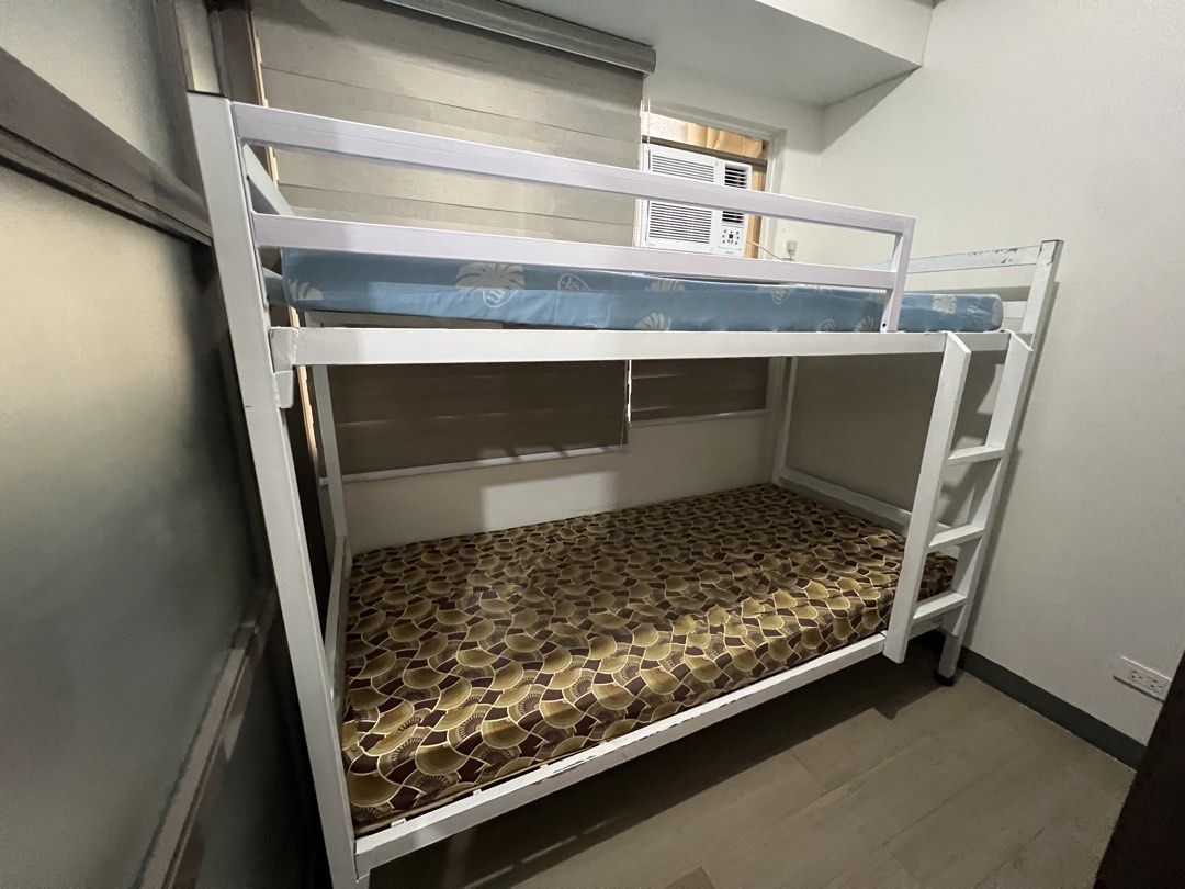 White Metal Bunk Bed (Category: Bed Frames & Mattresses) located in Mandaluyong City. Submitted by aamendoza (Listing ID 1464028241, Image 3). Description: - Sturdy white metal bunk bed frame - Minor scuffs and scratches from normal use - Excellent space-saving solution for bedrooms.
