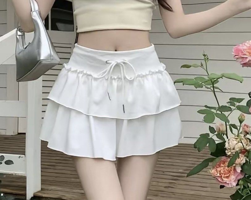 White Ruffled Tiered Mini Skirt with Drawstring Waist (Category: Skirts) located in Manila. Submitted by silver.declutterzz (Listing ID 1463949826, Image 1). Description: - Cute white mini skirt - Two ruffled tiers - Drawstring waist with ties - Light and flowy fabric - Ideal for summer or casual outings - Easy to style and comfortable.