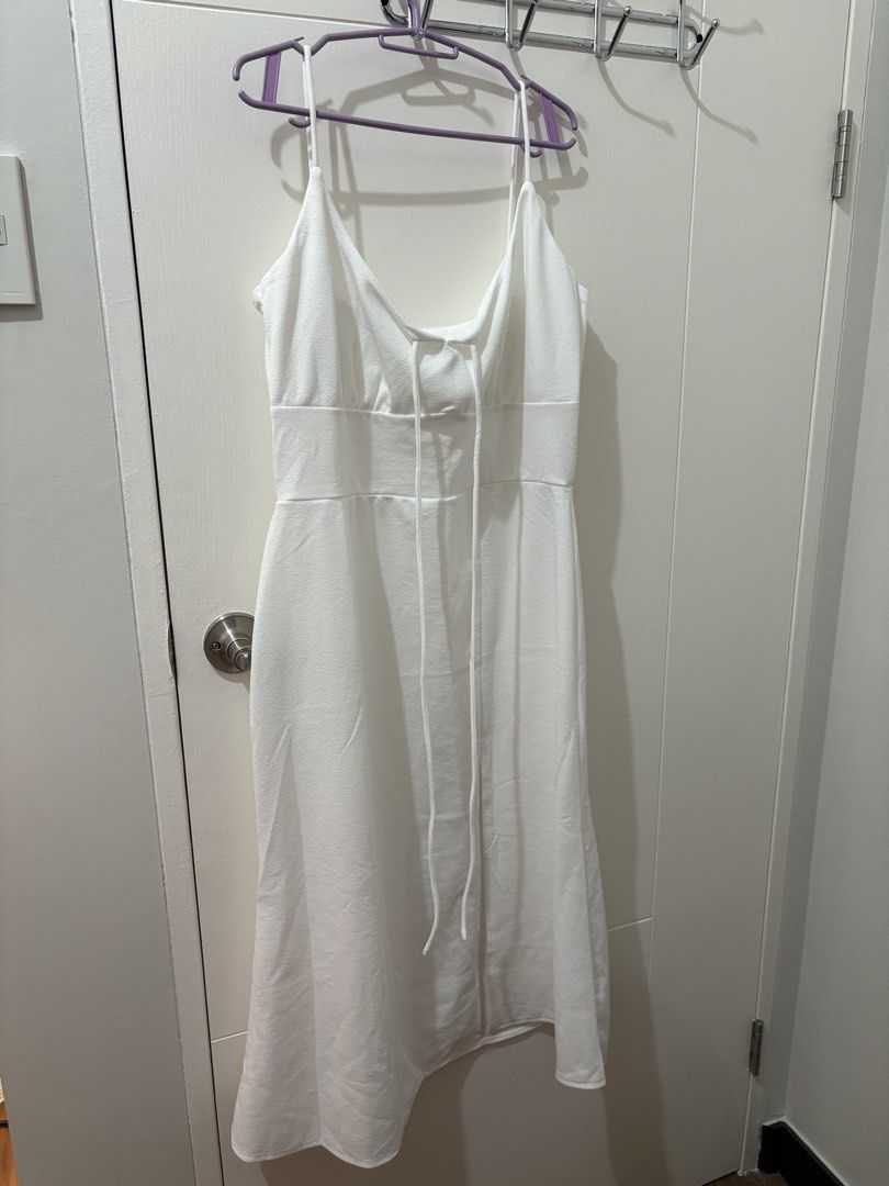 White Spaghetti Strap Midi Dress with Tie Front (Category: Dresses) located in Pasay City. Submitted by polly.unpockets (Listing ID 1464050775, Image 1). Description: - Elegant white midi dress - Delicate spaghetti straps - Flattering tie detail at the bust - Fitted waist with a flowy skirt - Versatile for events or a night out - Effortlessly chic and easy to style.