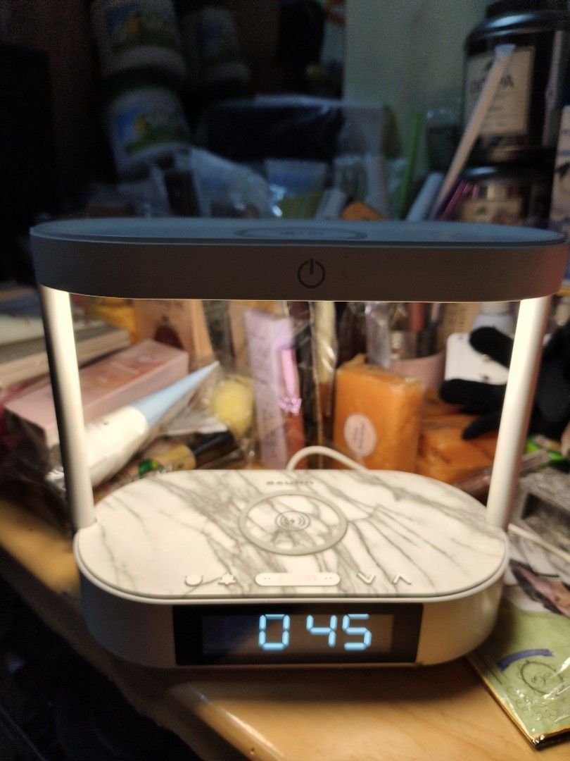 Wireless Charging Desk Lamp with Clock (Category: Lighting) located in Manila. Submitted by reascheyss51406 (Listing ID 1464020562, Image 2). Description: - BAUHN desk lamp with integrated wireless charging pad - Built-in clock display - Simple on/off power button operation - Stylish marble-like pattern on the base - Power adapter port located on the back - Fully functional and in good working condition.