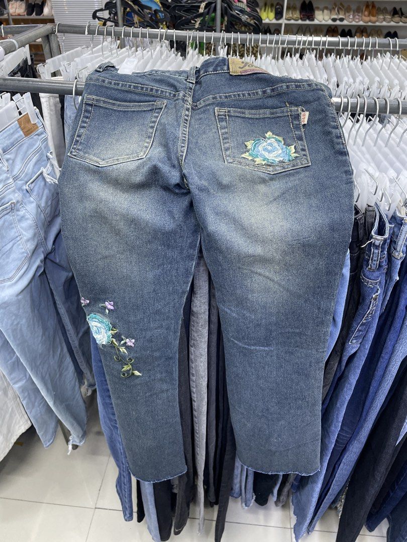 Y2k pants (Category: Jeans) located in Lucena. Submitted by riyizthriftz (Listing ID 1464126149, Image 2). Description: - Blue denim jeans - Unique floral embroidery on front and back - Trendy frayed hem detail - Classic five-pocket styling - Secure button and zip fly closure - Ideal for stylish casual wear.