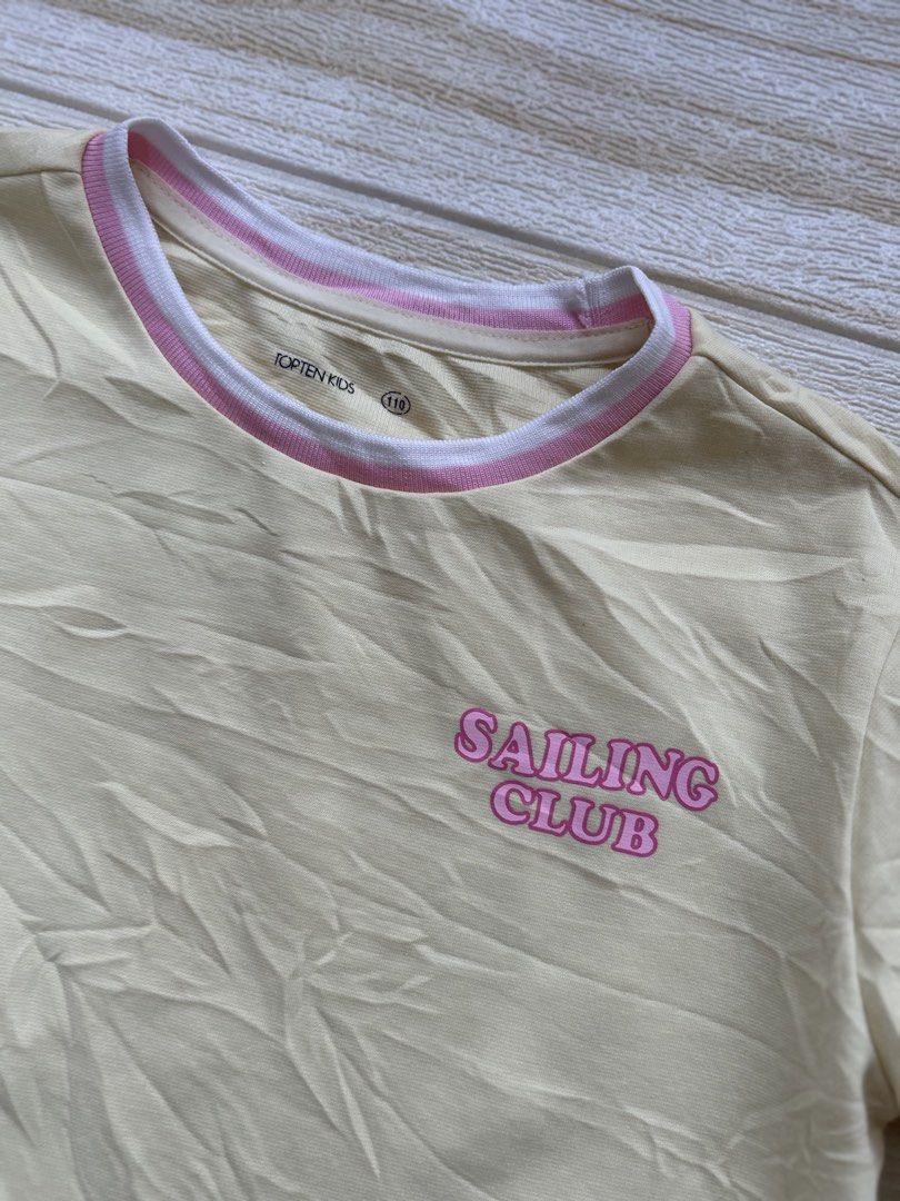 yellow Topten Kids tshirt (Category: Babies & Kids Fashion) located in Cebu City. Submitted by yjainani (Listing ID 1464033903, Image 2). Description: light yellow Topten Kids short-sleeved t-shirt featuring a pink "Sailing Club" graphic on the chest..