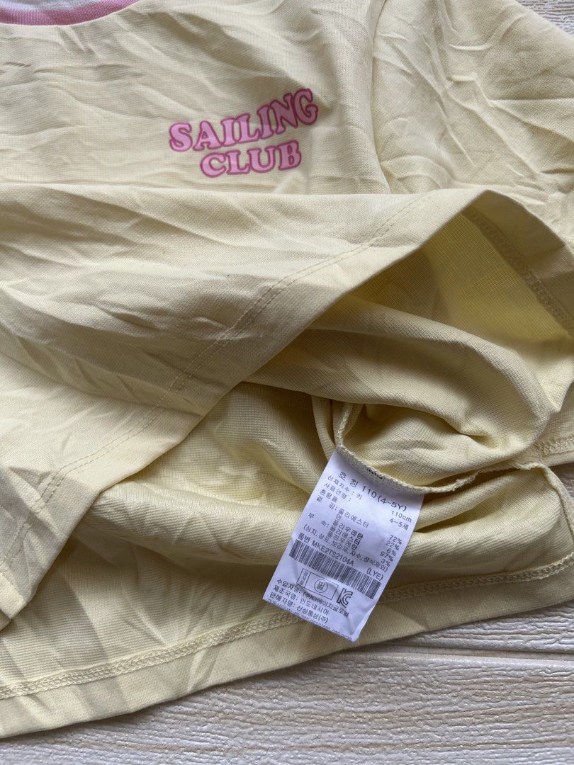 yellow Topten Kids tshirt (Category: Babies & Kids Fashion) located in Cebu City. Submitted by yjainani (Listing ID 1464033903, Image 3). Description: light yellow Topten Kids short-sleeved t-shirt featuring a pink "Sailing Club" graphic on the chest..