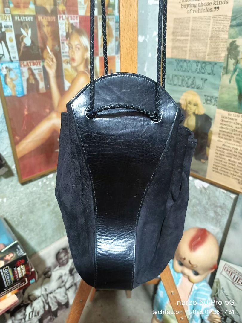 Yoshie Inaba Black Suede Leather Drawstring Bag (Category: Tote Bags) located in Santo Tomas. Submitted by pickers_corner (Listing ID 1464043248, Image 2). Description: YOSHIE INABA leather Suede drawstrig shouler/crossbody bag excellent condition no issue Yoshie Inaba black suede and leather drawstring bag - Features a braided strap and secure drawstring closure - Interior includes multiple compartments for organization - Unique shape and luxuri