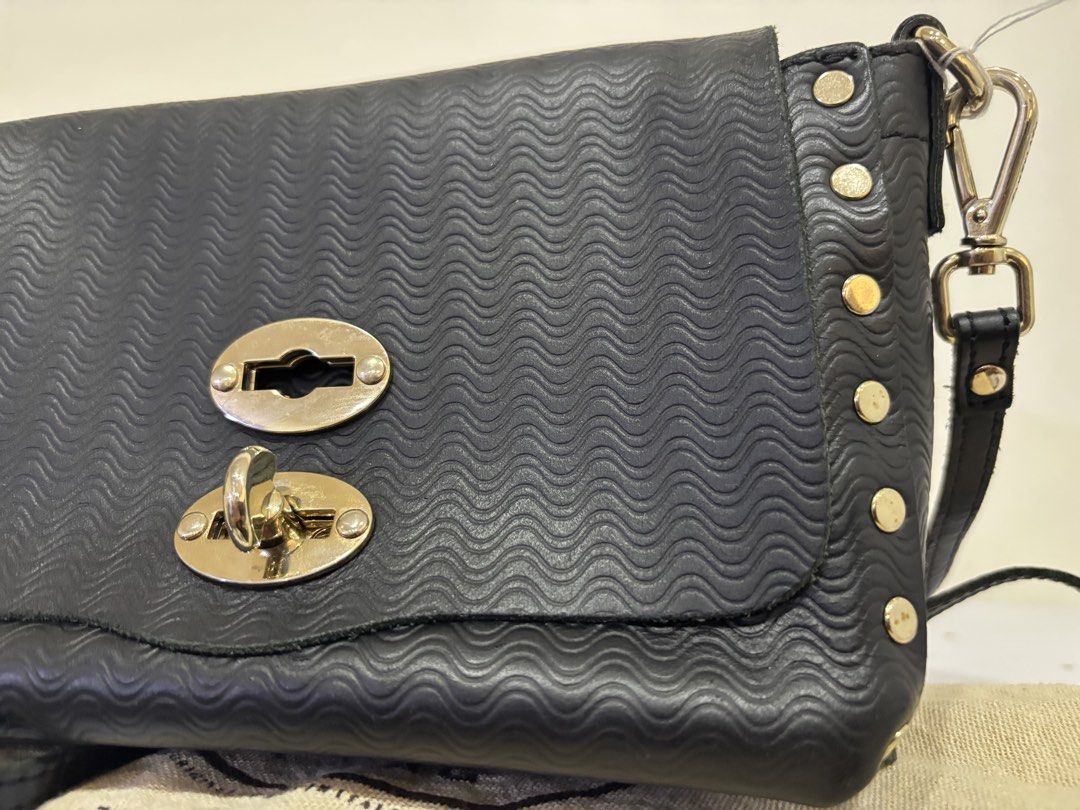 Zanellato Black Leather Studded Flap Bag (Category: Luxury Bags & Wallets) located in Malabon City. Submitted by everythingpreloveddd (Listing ID 1464024328, Image 2). Description: - Genuine black leather Zanellato bag - Distinctive wavy embossed pattern - Elegant gold stud details - Secure turn-lock closure - Comfortable top handle - Detachable shoulder strap for versatile wear - Comes with original dust bag - Ideal for both daytime and evening 