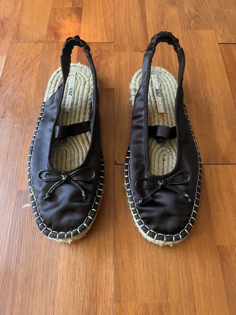 Zara Black Satin Slingback Espadrille Ballet Flat (Category: Flats & Sandals) located in Lipa City. Submitted by alexcollectionco (Listing ID 1464073545, Image 1). Description: Zara black satin slingback ballet flat espadrilles featuring a delicate bow tie on the toe cap, elasticated scrunchie heel strap, braided jute insoles, and contrast white topstitching around the welt. Size: EU 40 / US 9 Condition: Pre-owned condition. Satin uppers remain s