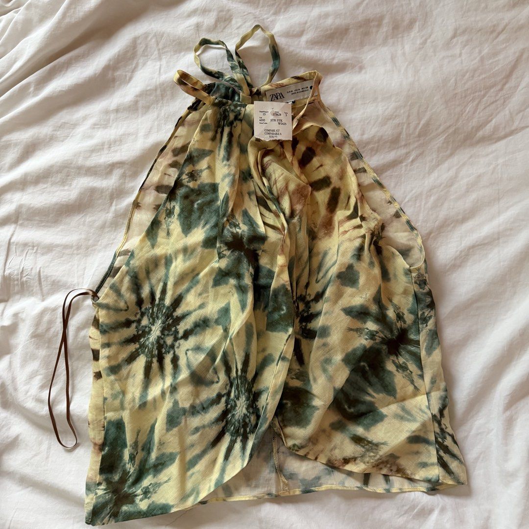 ZARA summer top (Category: Dresses) located in Mabalacat. Submitted by pauwieee12 (Listing ID 1464001396, Image 1). Description: - ZARA - Style: Yellow and green tie-dye maxi dress - Neckline: Halter neck with tie-up straps - Design: Lightweight, flowy - Occasion: Perfect for beach days or summer evenings - Size: Medium (M) - Condition: Brand new with original tags attached.