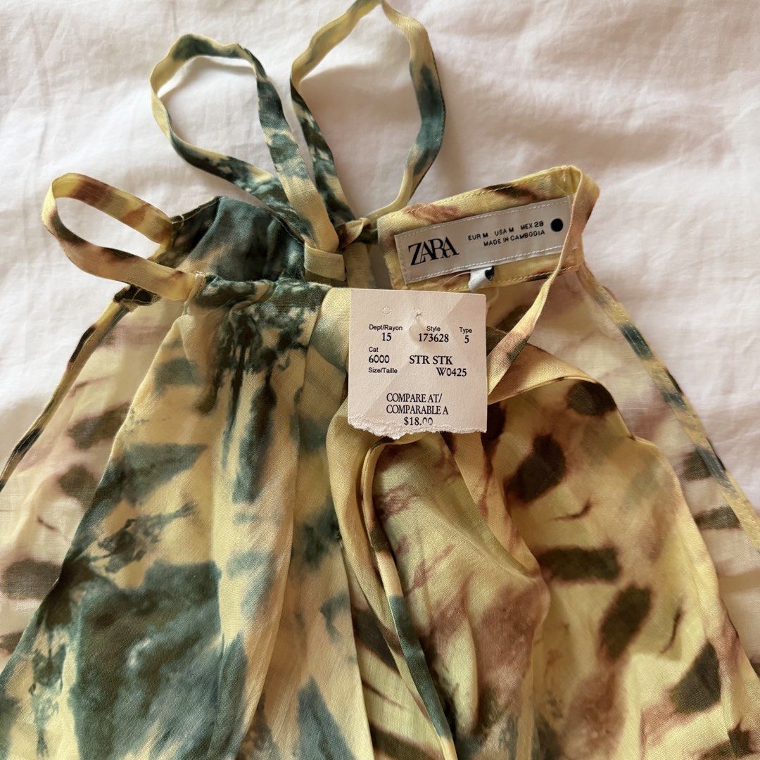 ZARA summer top (Category: Dresses) located in Mabalacat. Submitted by pauwieee12 (Listing ID 1464001396, Image 2). Description: - ZARA - Style: Yellow and green tie-dye maxi dress - Neckline: Halter neck with tie-up straps - Design: Lightweight, flowy - Occasion: Perfect for beach days or summer evenings - Size: Medium (M) - Condition: Brand new with original tags attached.