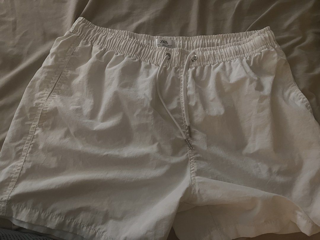 Zara White Swim Shorts Size L (Category: Shorts) located in Manila. Submitted by sethsethsethseth (Listing ID 1463983324, Image 1). Description: - White Zara shorts - Elastic waistband with drawstring - Inner mesh lining - Back pocket with button closure - Ideal for beach or pool days - Made in Bangladesh.