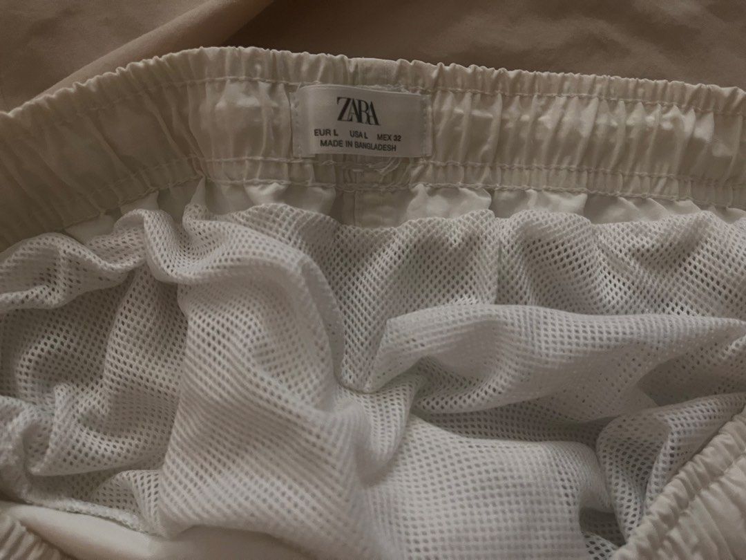 Zara White Swim Shorts Size L (Category: Shorts) located in Manila. Submitted by sethsethsethseth (Listing ID 1463983324, Image 2). Description: - White Zara shorts - Elastic waistband with drawstring - Inner mesh lining - Back pocket with button closure - Ideal for beach or pool days - Made in Bangladesh.
