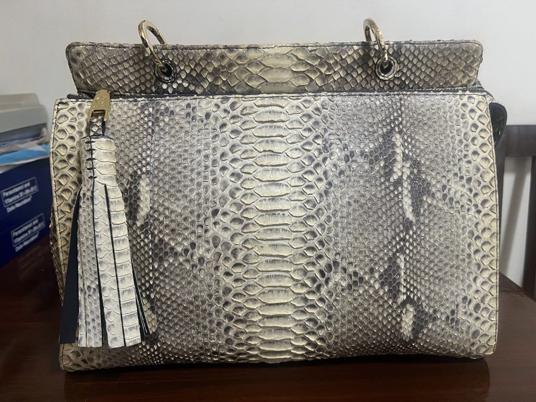 ZARMOI Genuine Python Snakeskin Handbag with Tassel Detail (Category: Luxury Bags & Wallets) located in Dipolog. Submitted by theagahisan (Listing ID 1463992641, Image 1). Description: - Genuine python snakeskin handbag - Unique scale pattern all over - Detachable shoulder strap included - Cute tassel charm - Elegant gold hardware details - Convenient top handle for carrying - Perfect statement piece for any outfit - Approximate dimensions: 12 in